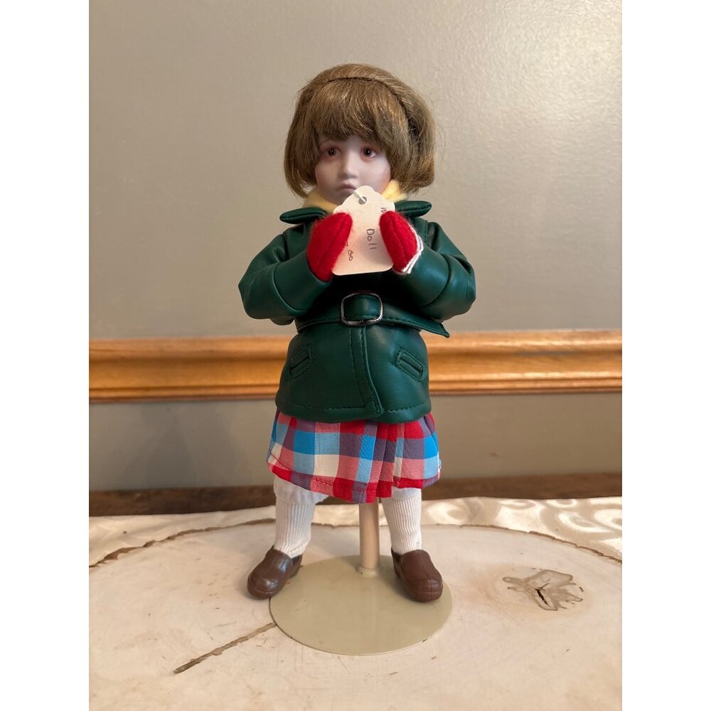Norman Rockwell's "Little Girl and Her Doll" porcelain doll the Danbury Mint.